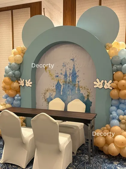 A dedicated activity station with a Mickey Mouse silhouette arch and a backdrop of the Disney castle, perfect for arts, crafts, or a caricature artist.