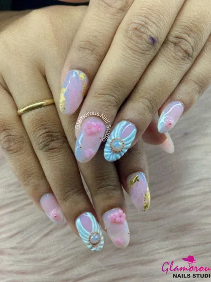 A truly dreamy and intricate set. We used a pastel marble base with flecks of gold leaf and added beautiful 3D elements, including soft pink flowers and a stunning blue and white winged charm with a central gem.