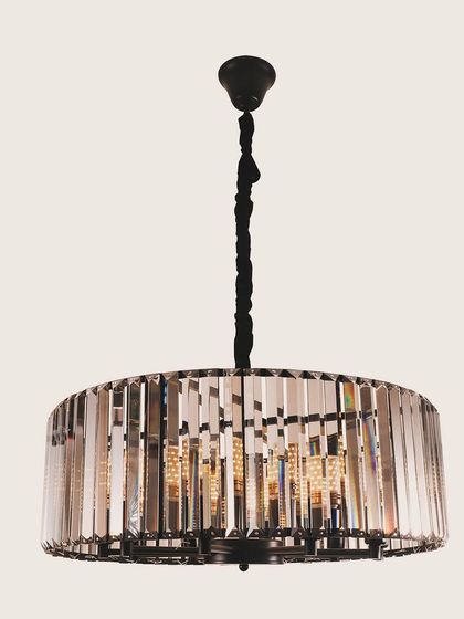 A drum chandelier with vertical crystal prisms. This design offers a clean, modern silhouette while still providing the classic sparkle of crystal.