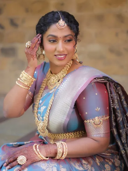 A happy and confident look. This image shows the bajuband (armlet) and bangles that are also part of this extensive temple jewellery rental set.
