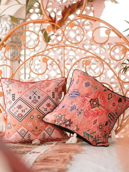 Close-up of custom-printed cushions with bohemian and tribal patterns. These details are essential for tying the whole decor theme together.