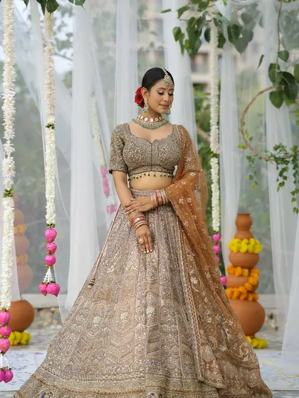 Nailing that modern Indian chic look. The makeup is sharp and clean, with a focus on perfectly defined eyes and a flawless base, using high-end products like Estee Lauder.