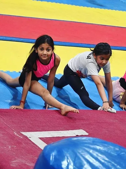 Another angle of our gymnasts working on their flexibility. We make sure to incorporate stretching in every class.