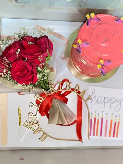 A full view of our birthday hamper, featuring a pink jar cake, a fresh rose bouquet, a birthday tiara, and candles, all neatly arranged in a gift box.