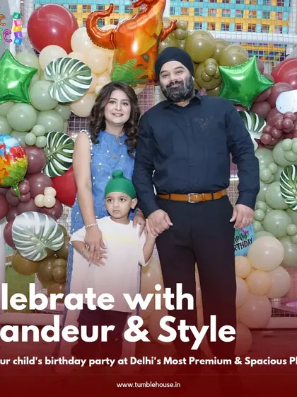 A happy family poses for a photo at their son's dinosaur-themed birthday party. The smiles say it all!