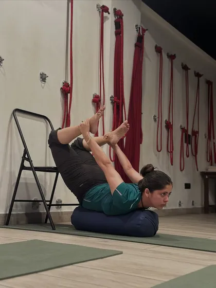 A closer look at the supported Dhanurasana. Notice how the bolster supports the abdomen and the chair provides stability for the legs. This precision allows the body to open and the breath to flow freely.