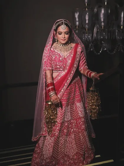A full-length shot of the bride Nilofer, looking like royalty. My training covers how to ensure the makeup complements the entire bridal ensemble, from the lehenga to the jewelry.