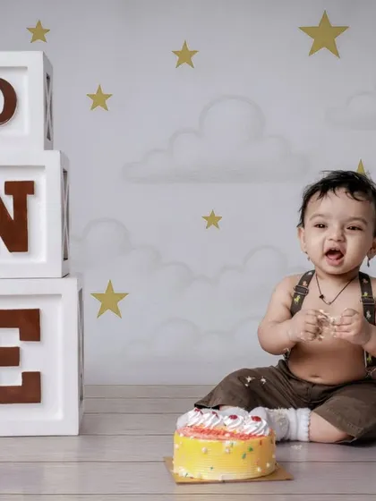 A triumphant and messy smile after a successful cake smash. We capture the aftermath of the fun, showcasing your child's playful personality.