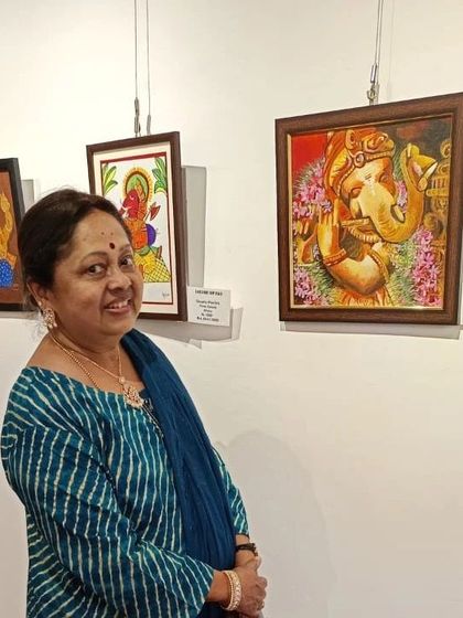 A visitor admiring my 'Murali Ganesha' painting at an exhibition. This piece features Ganesha playing the flute, surrounded by beautiful dhruva grass and flowers, all rendered in acrylics with a traditional touch.