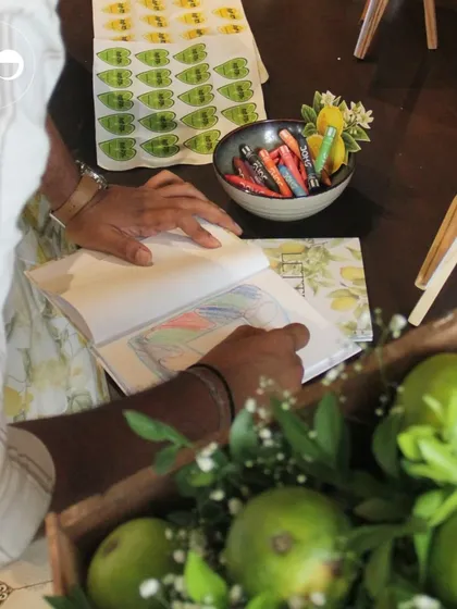 Another view of a guest enjoying the coloring book activity, a thoughtful detail that adds a layer of interactive fun to the celebration.