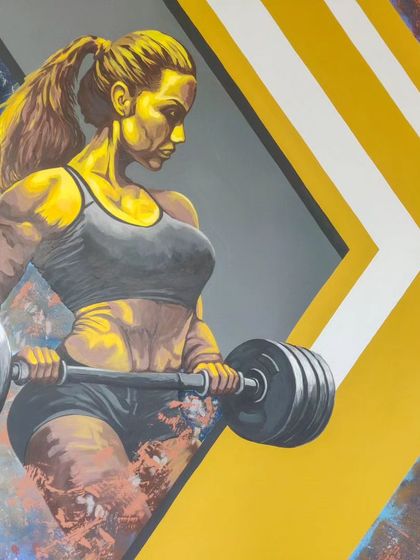 This detail from our gym mural shows a female weightlifter, rendered in a powerful graphic style. We create inclusive and inspiring artwork for all fitness enthusiasts.