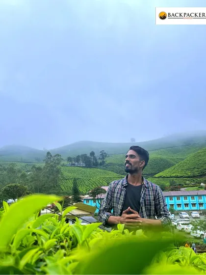 A moment of quiet reflection amidst the lush greenery of a Munnar tea estate.