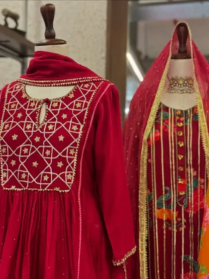 Rich red velvets perfect for winter celebrations. This display includes an anarkali with geometric embroidery and a printed suit with a veiled dupatta.
