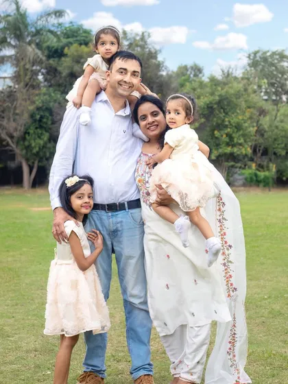 A bright and sunny outdoor family portrait. The natural setting allows for relaxed and genuine interactions, resulting in beautiful, candid memories.