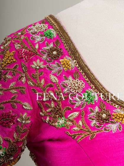 This bright pink raw silk blouse is a showcase of exquisite craftsmanship. The sleeves and back are covered in dense, multi-colored floral handwork, and I added beautiful custom tassels with bead detailing to complete the look.