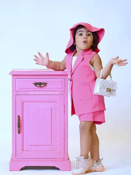 A playful and surprised expression makes this kid's fashion portrait memorable.