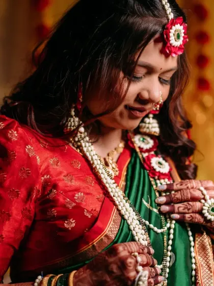A serene portrait of the mom-to-be, looking down with a gentle smile. Her soft glam makeup highlights her radiant skin.