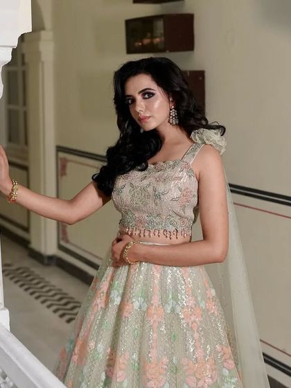 A full shot of the pastel floral lehenga, showing its elegant silhouette and soft color palette.
