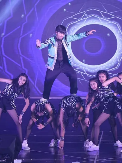 Our Bollyhop performance combines the energy of Bollywood dance with the athleticism of hip-hop and gymnastics. Here, students form a human platform for a dynamic solo moment.