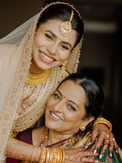 A precious moment between the bride and her mother. Both look beautiful with age-appropriate, elegant makeup.