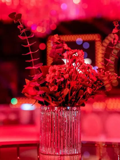 Even the smallest floral arrangements were thoughtfully composed, like this simple vase of red eucalyptus and statice, adding a touch of modern texture to the decor.