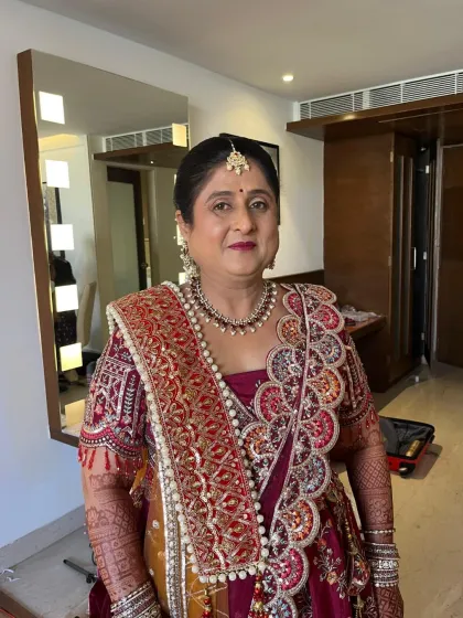 A full view of the client in her opulent wedding attire. The makeup is designed to balance the richness of her outfit.