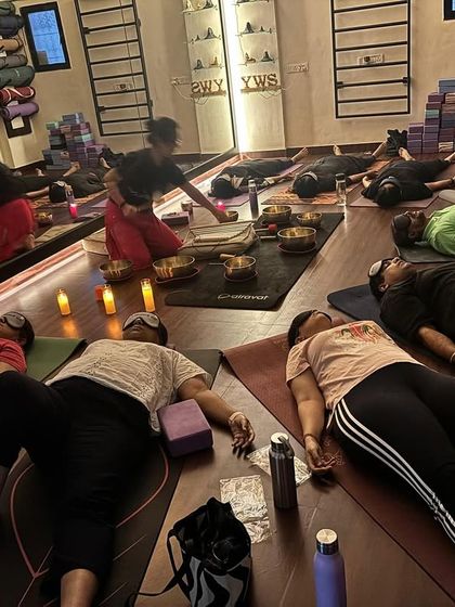 The studio transformed into a sanctuary for Naada Yoga. The arrangement of mats, candles, and bowls is done with intention to create a safe and sacred space for healing.