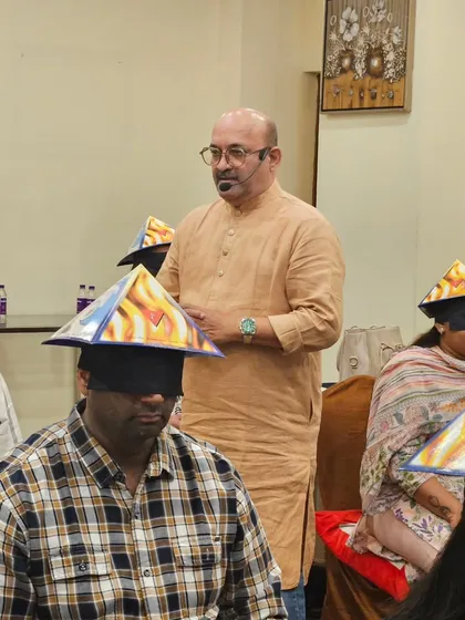 A powerful moment from my Sanjivani Holistic Remedial workshop. Here, participants are blindfolded and wearing pyramid hats to enhance their focus during a deep meditation exercise. These practical techniques help them connect with their inner energy and activate their intuitive senses, a core part of my teaching.