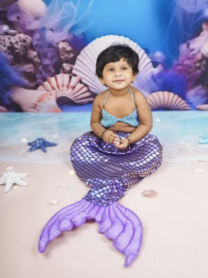 A sweet, serene portrait from the mermaid photoshoot. The soft lighting and blue tones create a beautiful under-the-sea effect.