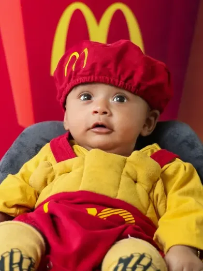 A close-up of our adorable McDonald's baby. The custom costume and vibrant backdrop make these photos pop.