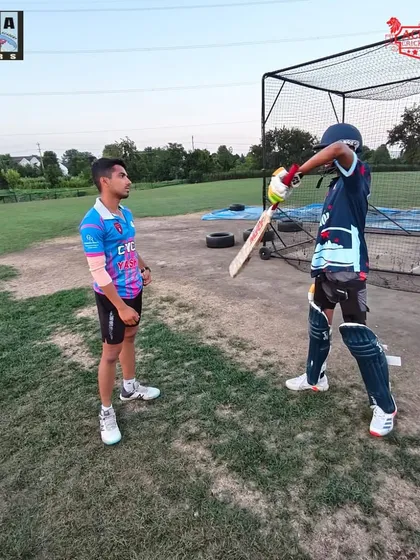 One-on-one mentorship is key. Here, one of our coaches provides personalized feedback on batting stance to a CYCA player during a training session in Chicago.