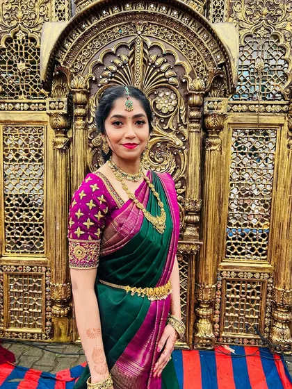 A beautiful portrait against an ornate gold backdrop. The makeup enhances her natural features, making her look elegant and festive.