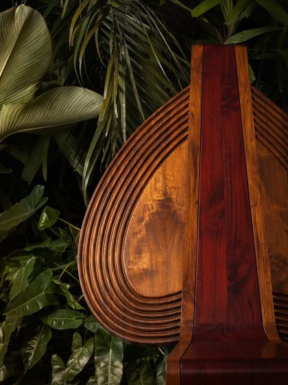 Various angles of the Vismayam chair, showcasing its intricate details, the contrast of different wood grains, and its powerful, sculptural presence. Each view offers a new perspective on this piece of collectible, art-inspired furniture.