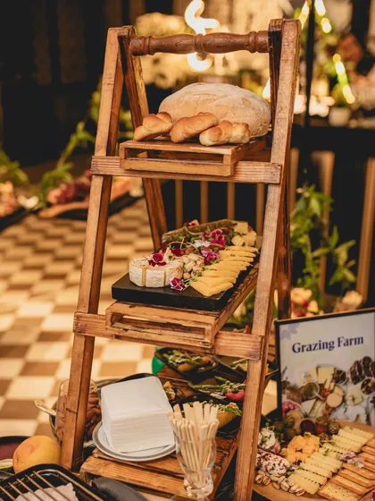 Another view of our "Grazing Farm" concept, showcasing the multi-level display of fresh breads and artisanal cheeses. This is how we blend functionality with creative event design.