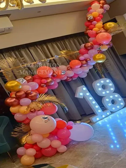 A vibrant and tropical-themed balloon garland for an 18th birthday. I used shades of pink, orange, and coral, with gold accents and palm leaves for a fun, party-ready look.