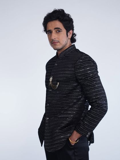 A side view of the black striped bandhgala jacket, showing its sharp tailoring and modern fit.