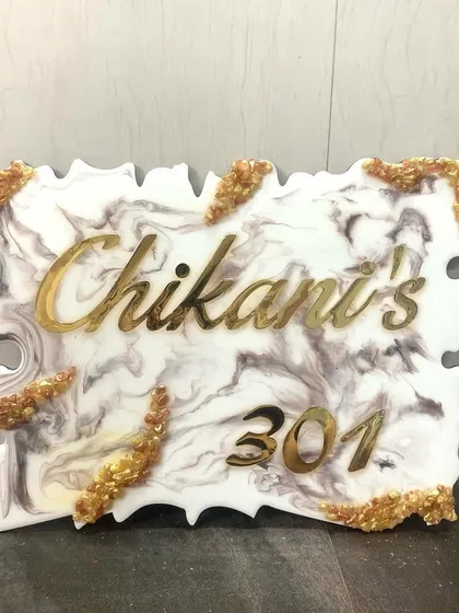 Welcome guests with a beautiful, handmade nameplate. This piece features a white and grey marble resin design with elegant gold lettering for the family name and house number. I can customize the colors and style to perfectly match your home's entrance.