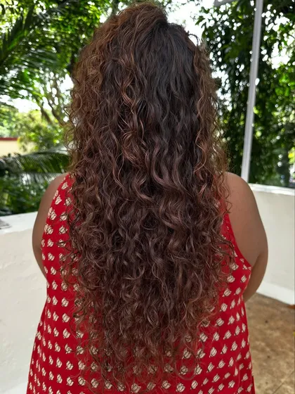 Once you embrace your curls, you never go back. For her new job, we did a haircut to reshape her curls and added highlights to make them stand out.
