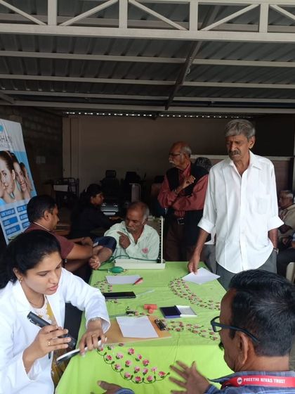 Listening carefully to a patient's concerns at the community health camp. Good communication is the first step towards effective treatment.