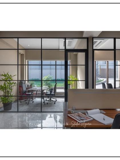 This shot from an employee's perspective shows a clear view into a manager's office, reinforcing the theme of a transparent and non-hierarchical work environment.