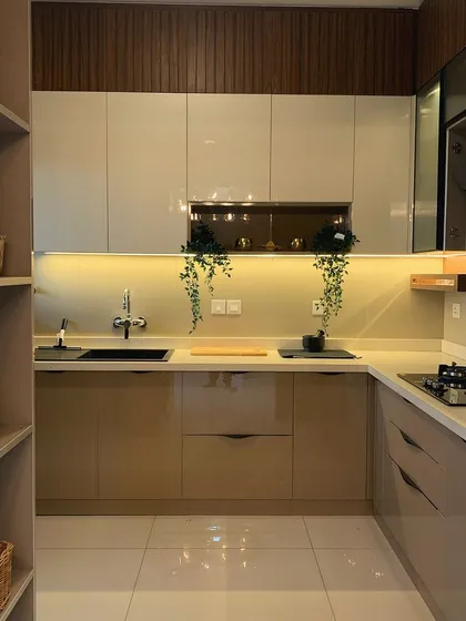 A beautiful and practical kitchen design with a dual-color combination. The open shelving and under-cabinet lighting not only look great but also add to the functionality of the space.