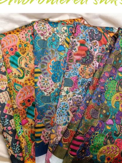 A selection of my embroidered and printed silks, showcasing the variety of colors and patterns available for your custom designs.