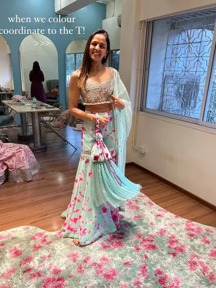 When your outfit perfectly coordinates with the decor. I'm trying on a beautiful sharara set that matches the floral carpet, a happy accident during a shopping trip.