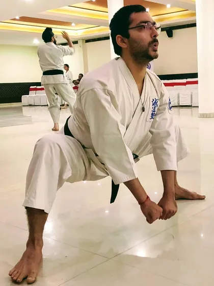 Stretching beyond your perceived limits will yield powerful results. This deep horse stance builds leg strength, stability, and mental endurance.