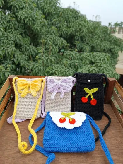 My handmade phone sling bags are perfect for college fests or as quirky additions to a retail shop. This collection shows some of the custom designs I offer in bulk, including bow, cherry, and floral motifs in various colors.