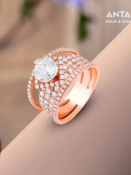 This ring marks the beginning of forever. A brilliant solitaire diamond is held within a contemporary rose gold setting paved with smaller diamonds, designed as a symbol of an eternal spark for the modern bride.