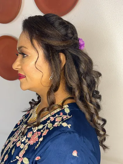Another angle of the hairstyle, showing how the flowers are incorporated into the curls.