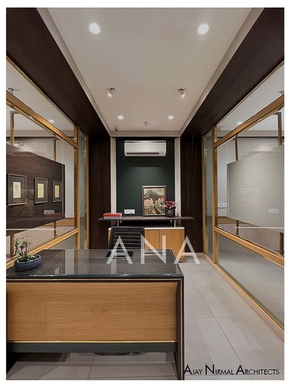 A view from behind the reception desk, looking into the office. The design uses partitions and ceiling details to create zones within a relatively small footprint.