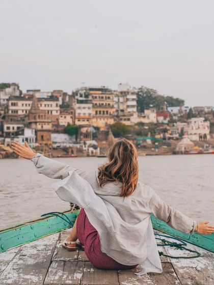 Arms open to the soul of the city. This shot captures a moment of pure freedom and connection with Varanasi's spiritual energy.