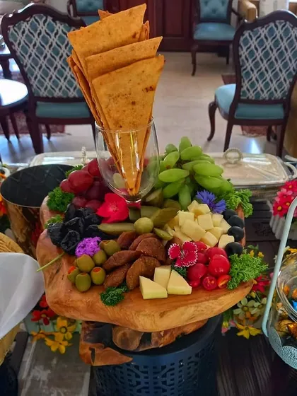 Beyond the classics, I create stunning continental platters that wow your guests. This beautiful cheese board, with a mix of cheeses, fruits, and crackers, is a perfect example of how I can add a touch of modern elegance to your menu.